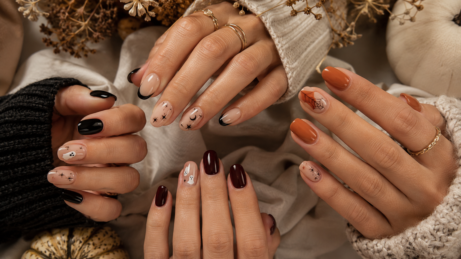 Halloween nail ideas with black French tips, tiny ghosts, burgundy polish, stars, and subtle orange details